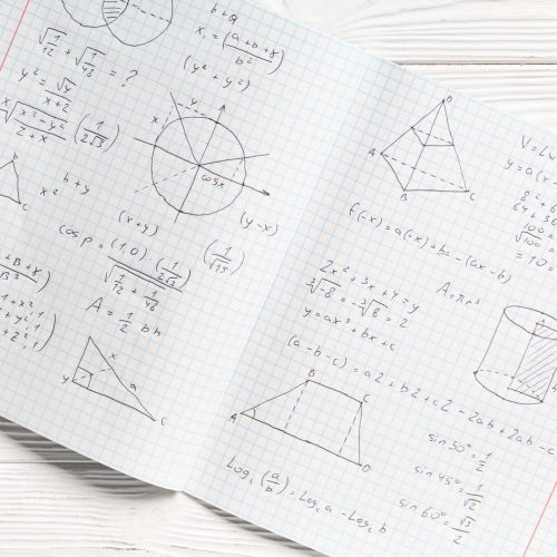 Copybook,With,Handwritten,Maths,Formulas,On,White,Wooden,Background